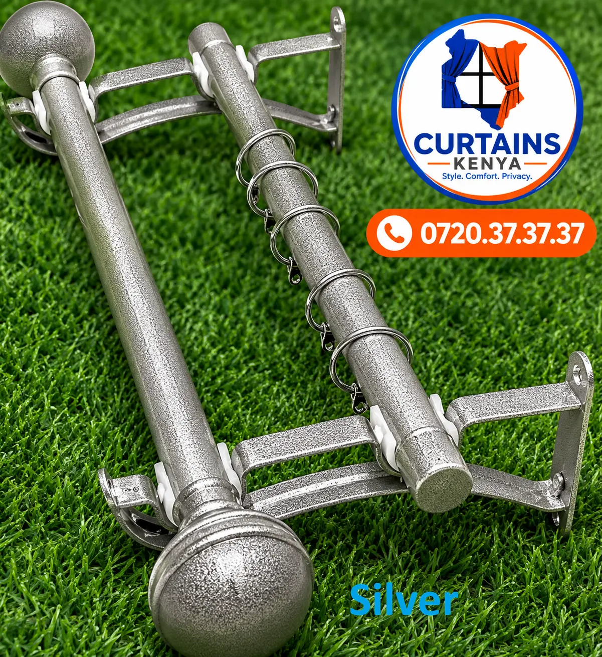 Speckled silver double curtain rods with round finials, rings and wall brackets on green turf